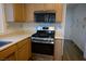 Kitchen with stainless steel oven and cooktop and light wood cabinetry at 8901 Kingsmill Dr, Las Vegas, NV 89134