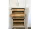 Custom wood pullout storage drawers inside of the white kitchen cabinets at 8901 Kingsmill Dr, Las Vegas, NV 89134