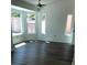 Bright living room with hardwood floors, multiple windows, and a ceiling fan, perfect for cozy living at 8901 Kingsmill Dr, Las Vegas, NV 89134