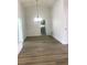 Bright living room featuring vaulted ceiling and wood laminate flooring, open to the kitchen at 8901 Kingsmill Dr, Las Vegas, NV 89134
