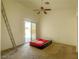 Spacious bedroom featuring a ceiling fan, sliding glass doors, and ample natural light at 8940 Emery Lake St, Las Vegas, NV 89123