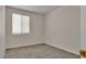 Bright bedroom with neutral walls, carpet, and a window with white blinds at 8940 Emery Lake St, Las Vegas, NV 89123