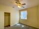 A cozy bedroom featuring a ceiling fan, closet, and window allowing plenty of natural light at 8940 Emery Lake St, Las Vegas, NV 89123