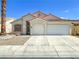 Charming single-story home with a well-maintained front yard and a two-car garage at 8940 Emery Lake St, Las Vegas, NV 89123