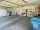 Spacious garage providing parking and storage solutions with shelving and overhead lighting at 8940 Emery Lake St, Las Vegas, NV 89123