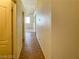Hallway with neutral walls, tile flooring, and great natural light from a nearby window at 8940 Emery Lake St, Las Vegas, NV 89123