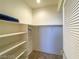 Bright, walk-in closet with built-in shelves and a hanging rod for organization and storage at 8940 Emery Lake St, Las Vegas, NV 89123