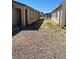 Gravel backyard area between two buildings and a chain link fence at , Las Vegas, NV 89106