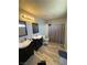 Bathroom with double vanities, dark cabinets and a shower with neutral tile at , Las Vegas, NV 89106