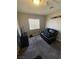 Bedroom or Personal cave with carpet, a window, black loveseat, and TV at , Las Vegas, NV 89106