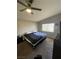Cozy bedroom with a ceiling fan, a large window, and neutral walls and carpet at , Las Vegas, NV 89106