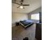 Cozy bedroom with a ceiling fan, a large window, and neutral walls and carpet at , Las Vegas, NV 89106