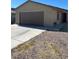 Tan single story house with brown two car garage door and front door at , Las Vegas, NV 89106