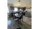 Kitchen and dining area with dark cabinets, stainless steel appliances, and table at , Las Vegas, NV 89106