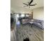 Open-concept living room with a TV, gray sectional, and view into kitchen at , Las Vegas, NV 89106