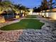 Serene backyard with putting green and mature palm trees, creating a private outdoor retreat at , Las Vegas, NV 89146