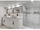 Modern bathroom featuring a double sink vanity and a glass-enclosed walk-in shower with white marble tiling at , Las Vegas, NV 89146