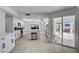Contemporary kitchen featuring white cabinetry, stone countertops, stainless steel appliances and sliding glass door access to the patio at , Las Vegas, NV 89146