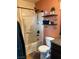 Bathroom featuring a combined shower and tub, complemented by industrial-style shelving and unique decor at 10403 Fancy Fern St, Las Vegas, NV 89183