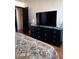 Comfortable bedroom featuring a dresser, TV, and stylish decor at 10403 Fancy Fern St, Las Vegas, NV 89183