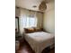 Cozy bedroom featuring a comfortable bed, soft lighting, and a window with natural light, and wood floors at 10403 Fancy Fern St, Las Vegas, NV 89183