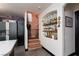 Unique hallway with patterned stairs and a decorative shelving niche adds character to the home's interior design at 10403 Fancy Fern St, Las Vegas, NV 89183