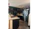 Updated kitchen with black cabinetry, modern appliances, and stylish brick accent wall at 10403 Fancy Fern St, Las Vegas, NV 89183