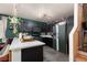 Stylish kitchen features dark cabinetry, modern appliances, and a unique, custom design for a contemporary look at 10403 Fancy Fern St, Las Vegas, NV 89183