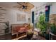 Bright living room features a daybed, indoor plants, ceiling fan and access to the outdoors at 10403 Fancy Fern St, Las Vegas, NV 89183