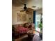 Cozy room featuring a unique ceiling fan and comfortable seating, complemented by natural light and accent plants at 10403 Fancy Fern St, Las Vegas, NV 89183