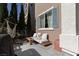Relaxing patio area with hammock swing, a comfortable seating area, and green foliage at 10403 Fancy Fern St, Las Vegas, NV 89183