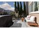 Relaxing patio area with hammock swing, a comfortable seating area, and green foliage at 10403 Fancy Fern St, Las Vegas, NV 89183