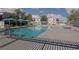 Community pool surrounded by lounge chairs, trees, and covered seating area at 10403 Fancy Fern St, Las Vegas, NV 89183