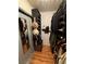 Organized walk-in closet with shelves, drawers, and ample hanging space and wooden floors at 10403 Fancy Fern St, Las Vegas, NV 89183