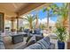 Relaxing covered patio with comfortable seating and a view of the landscaped backyard at 10408 Mezzanino Ct, Las Vegas, NV 89135