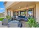 Stylish covered patio offering comfortable seating, a ceiling fan, and serene backyard views at 10408 Mezzanino Ct, Las Vegas, NV 89135