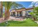 Beautiful home with lush landscaping, a comfortable patio area, and a built-in barbecue at 10408 Mezzanino Ct, Las Vegas, NV 89135