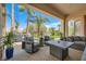 Outdoor patio with comfortable seating, a grill, and a beautifully landscaped backyard at 10408 Mezzanino Ct, Las Vegas, NV 89135