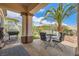 Charming backyard with outdoor dining, lush landscaping, and a barbecue area at 10408 Mezzanino Ct, Las Vegas, NV 89135