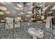 Stylish powder room with patterned walls, a pedestal sink, and decorative towels at 10408 Mezzanino Ct, Las Vegas, NV 89135