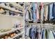 This closet offers ample storage with organized shelves for shoes and accessories, along with rods for hanging clothes at 10408 Mezzanino Ct, Las Vegas, NV 89135