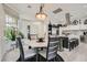 Dining area with a marble table, stylish chairs, and natural light flowing through the window at 10408 Mezzanino Ct, Las Vegas, NV 89135