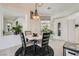 Cozy dining area with a round table, soft lighting, and views into other areas of the home at 10408 Mezzanino Ct, Las Vegas, NV 89135
