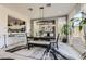 Bright dining room with a large table, modern chandelier, and views to the open-concept kitchen at 10408 Mezzanino Ct, Las Vegas, NV 89135
