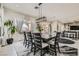 Stylish dining room features a large table, modern chairs, and views of the well-appointed living space at 10408 Mezzanino Ct, Las Vegas, NV 89135