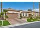 Tan stucco home with a tile roof, brown trim, desert landscaping, and a two-car garage at 10408 Mezzanino Ct, Las Vegas, NV 89135