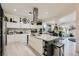 Modern kitchen with stainless steel appliances, white cabinetry, an island with seating, and sleek countertops at 10408 Mezzanino Ct, Las Vegas, NV 89135