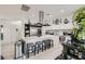 Modern kitchen with a large island with seating, stainless steel appliances, and stylish accents at 10408 Mezzanino Ct, Las Vegas, NV 89135
