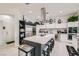 Well-lit kitchen boasting a large island with seating, stainless steel appliances, and modern white cabinetry at 10408 Mezzanino Ct, Las Vegas, NV 89135