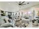 Spacious living room with plush seating, bright natural light, and modern decor at 10408 Mezzanino Ct, Las Vegas, NV 89135